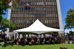 Crowd seated under tent at gathering outside of Kalana o Maui.