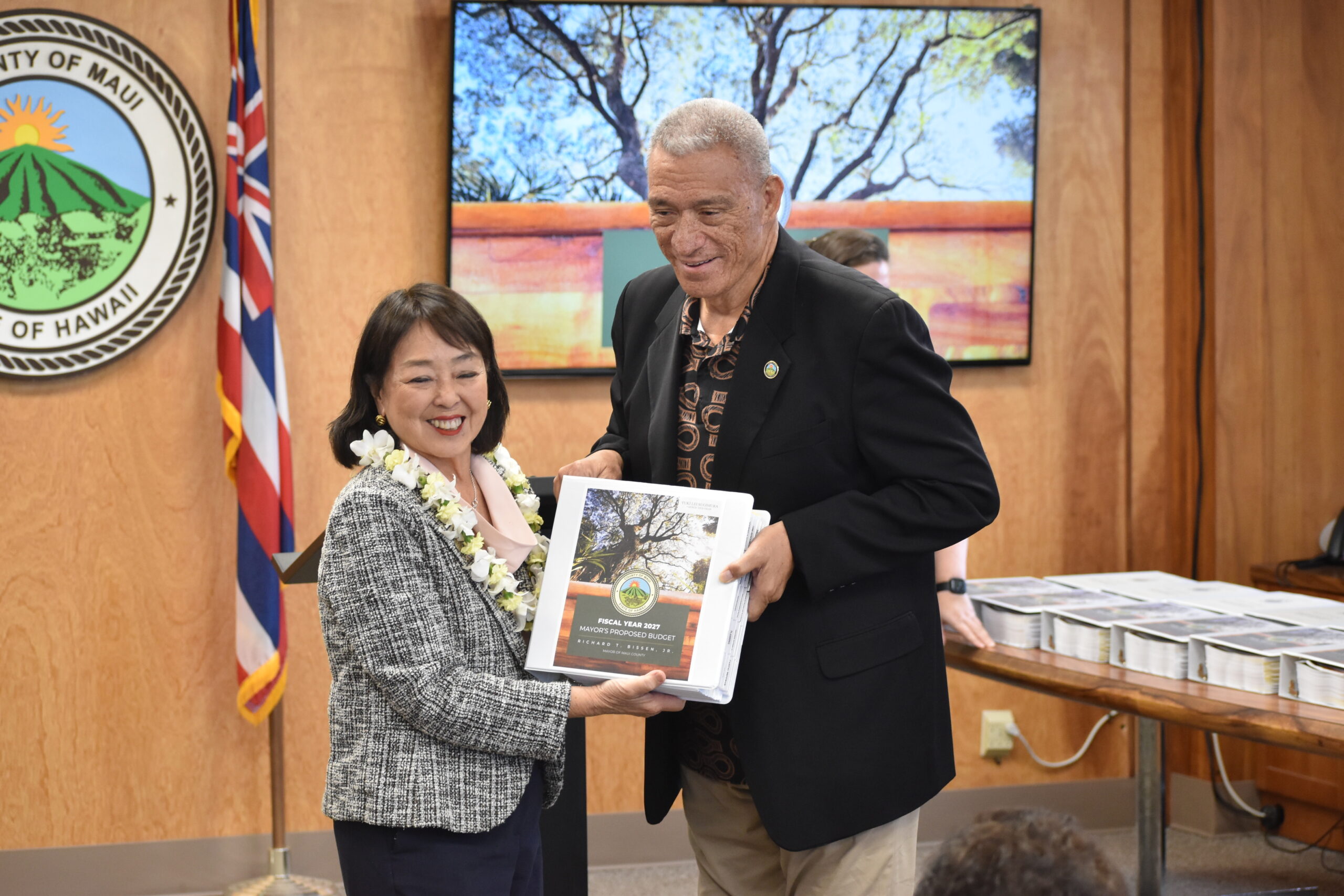 Vice-Chair Sugimura is handed a copy of the FY 2027 Mayorʻs Proposed Budget.