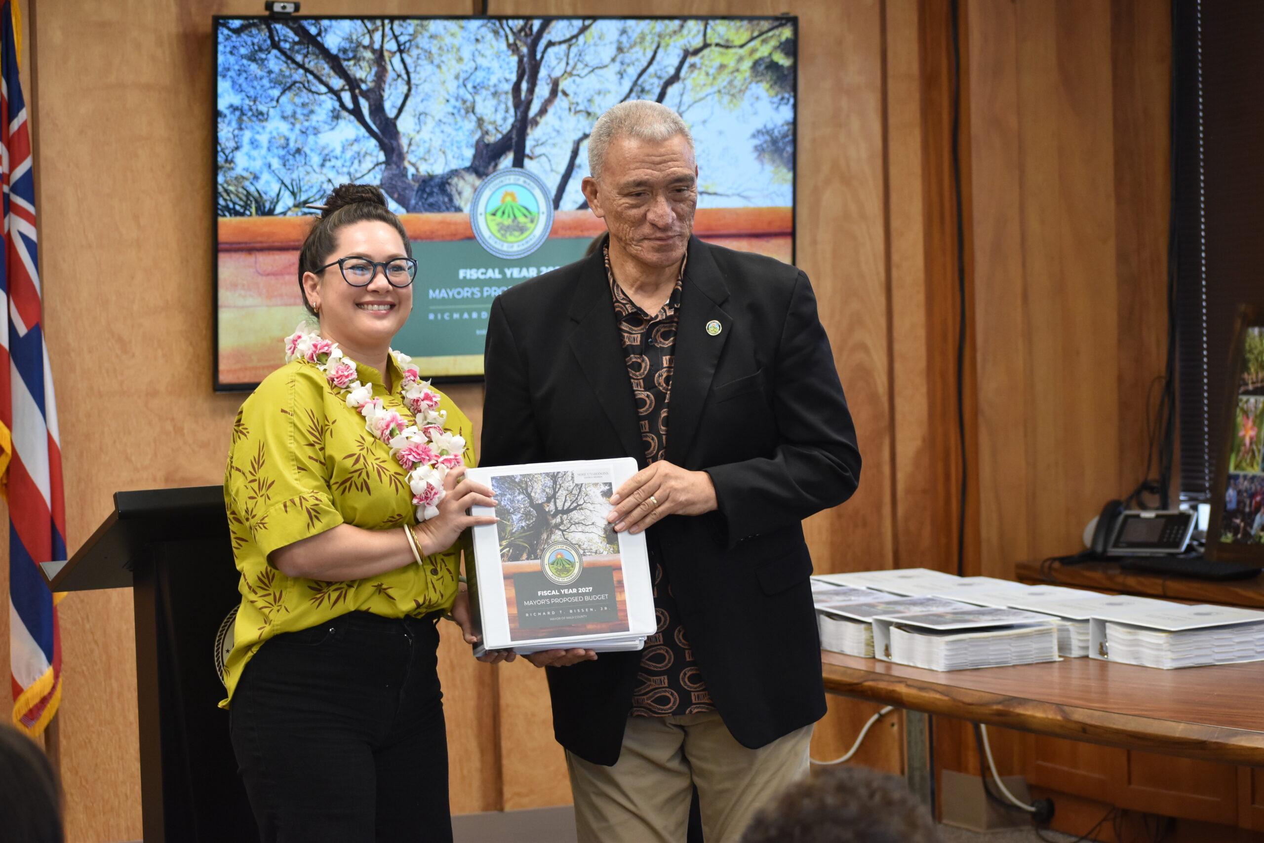 Councilmember Uʻu-Hodgins is handed a copy of the FY 2027 Mayorʻs Proposed Budget.