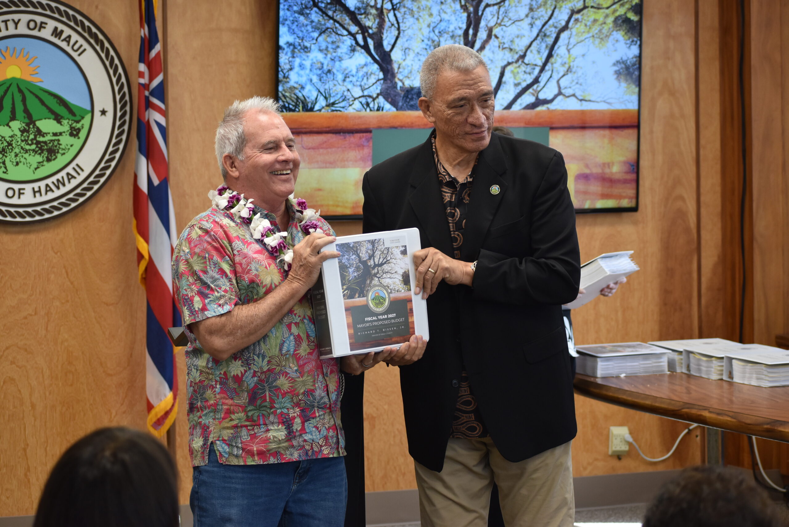 Councilmember Cook is handed a copy of the FY 2027 Mayorʻs Proposed Budget.