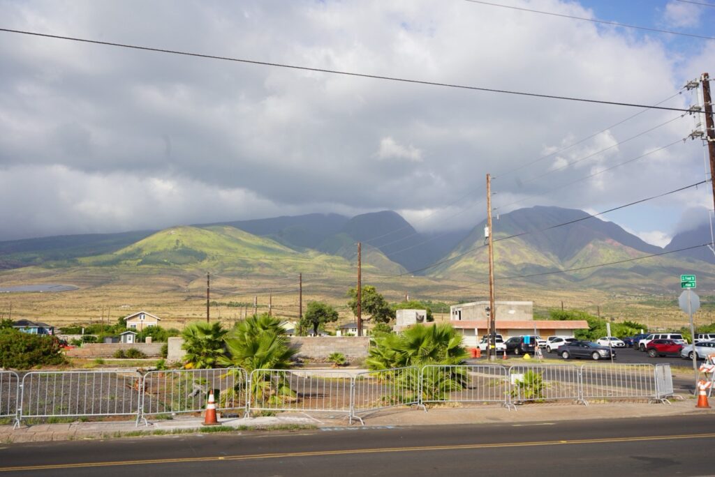 Photo taken in Lahaina town at the corner of Front Street and Prison Street with newly built homes in the background and the West Maui Mountains.